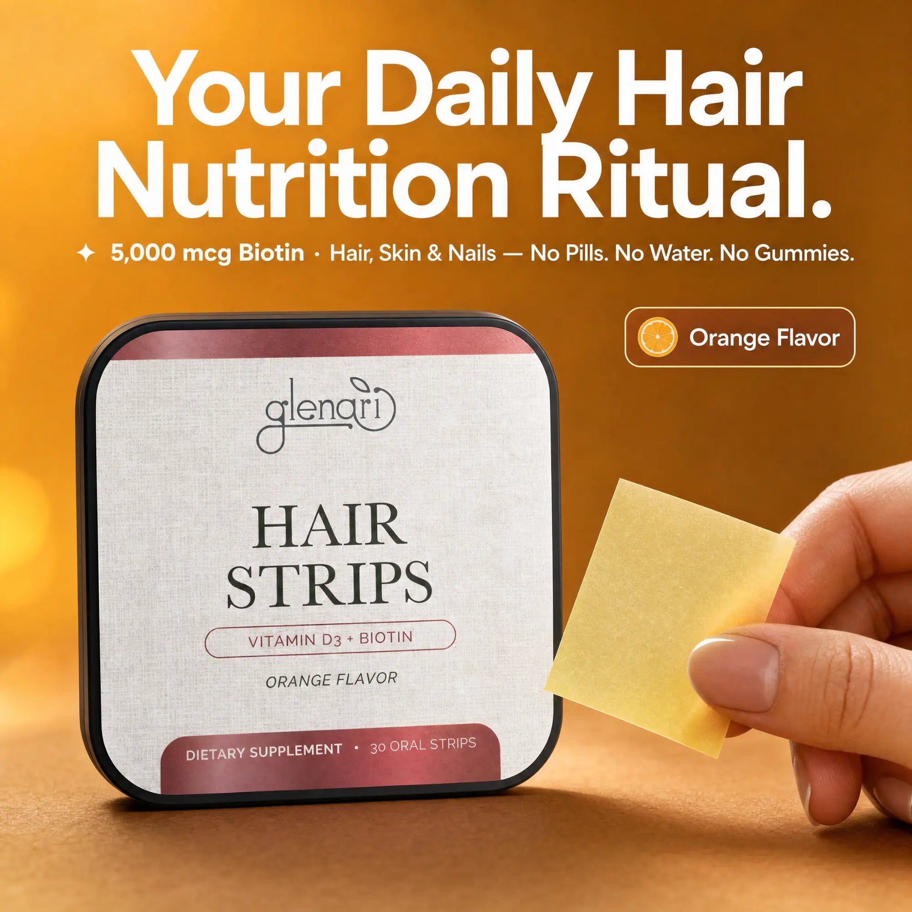A hand holds an orange-flavored hair strip while a square tin of Glenari Hair Strips sits on a warm brown surface. Large text at the top reads, 'Your Daily Hair Nutrition Ritual.