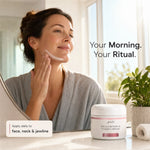 A woman in a gray robe applies cream to her face while looking into a mirror in a bright bathroom. A white jar of Glenari Hyaluronic & CoQ10 Cream is shown in the foreground with text reading 'Your Morning.