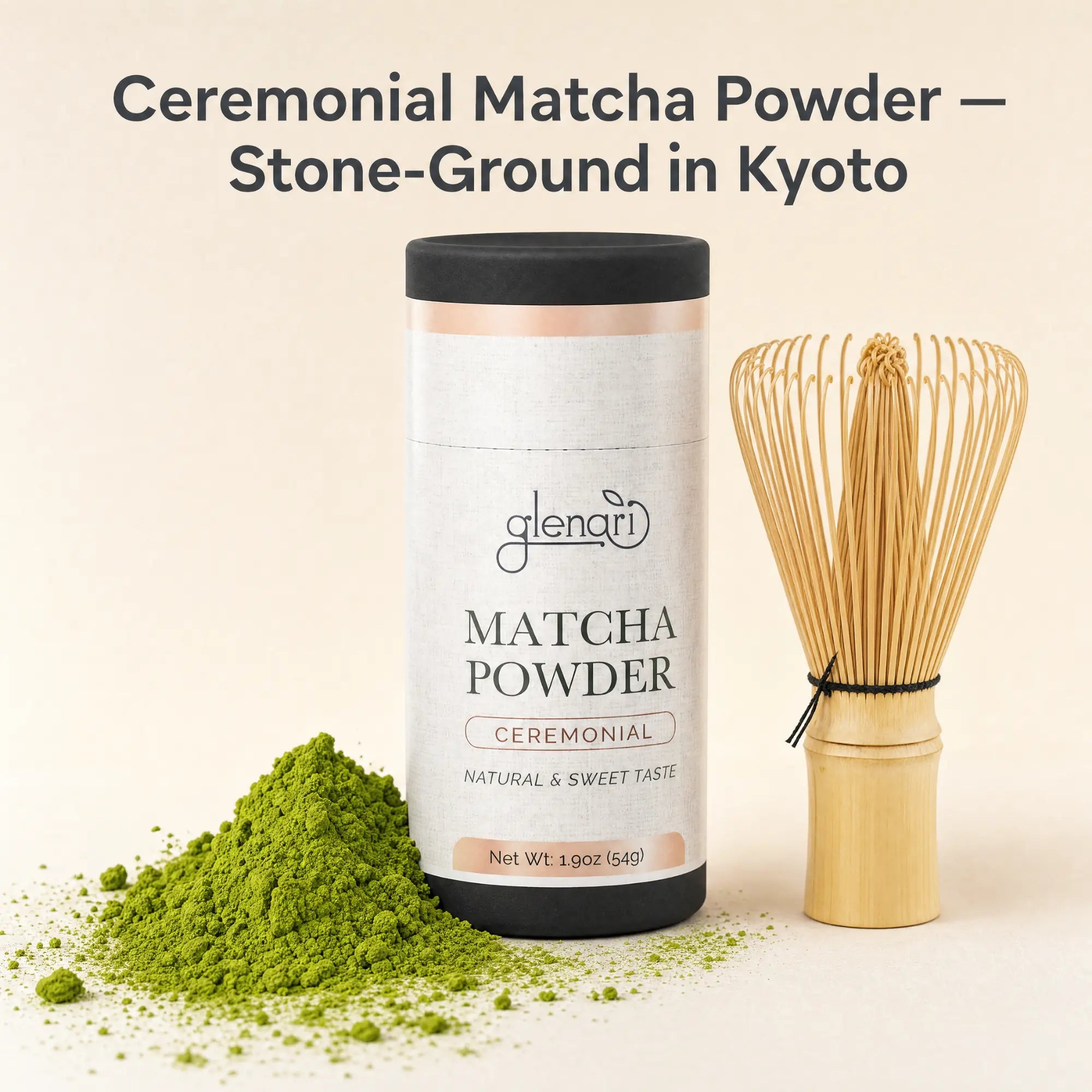 Glenari ceremonial matcha powder in a white cylindrical container with a black lid, shown beside a bamboo whisk and a small pile of bright green matcha powder on a warm beige background. Text at the top reads 'Ceremonial Matcha Powder — Stone-Ground in Kyoto'.