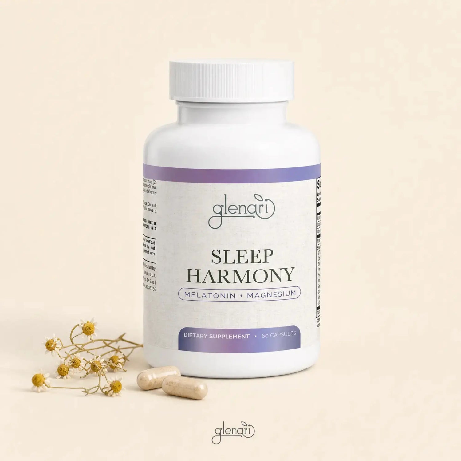 A white bottle of Glenari Sleep Harmony dietary supplement with purple label accents, shown on a warm beige background with two capsules and small dried flowers beside it.