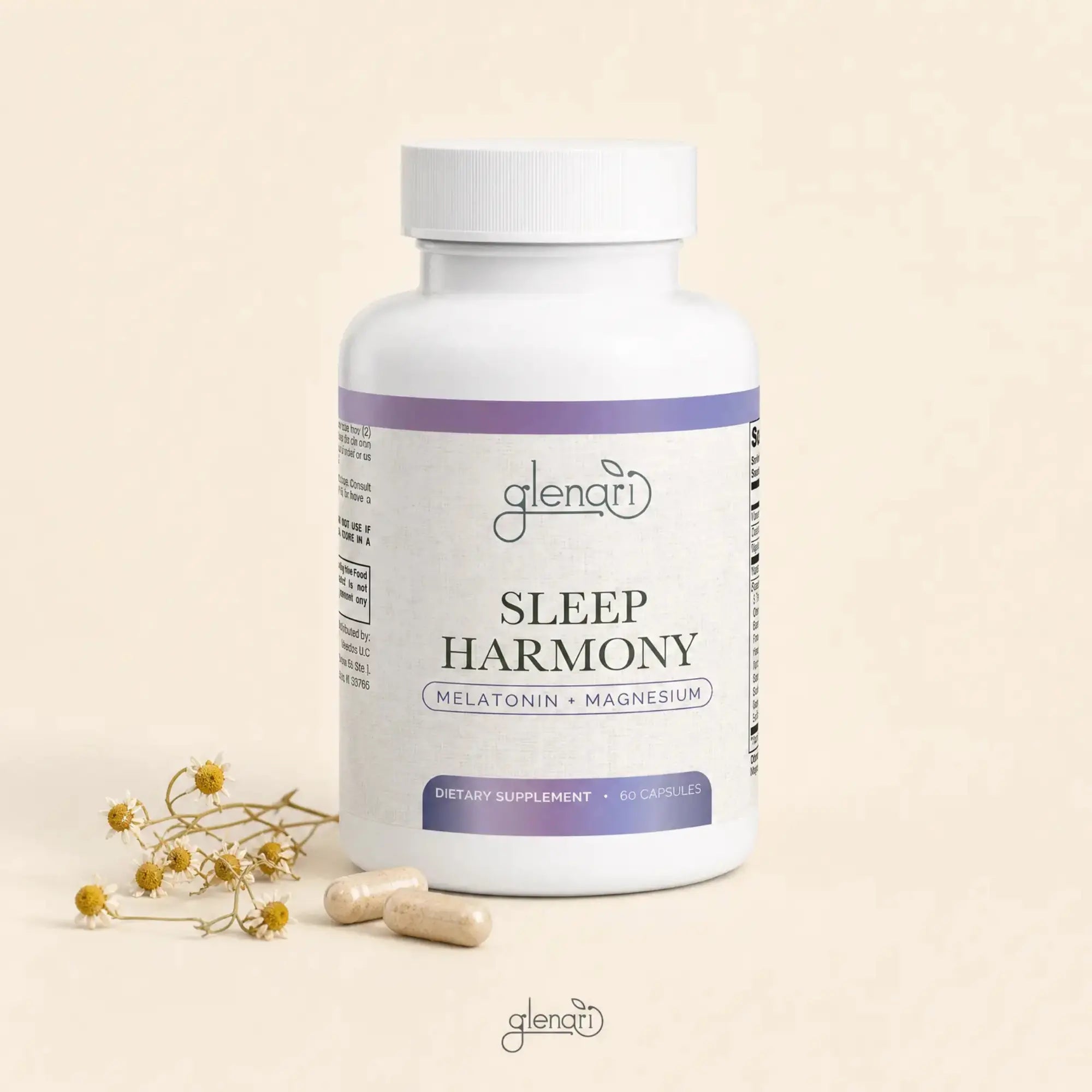 A white bottle of Glenari Sleep Harmony dietary supplement with purple label accents, shown on a warm beige background with two capsules and small dried flowers beside it.