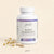A white bottle of Glenari Sleep Harmony dietary supplement with purple label accents, shown on a warm beige background with two capsules and small dried flowers beside it.